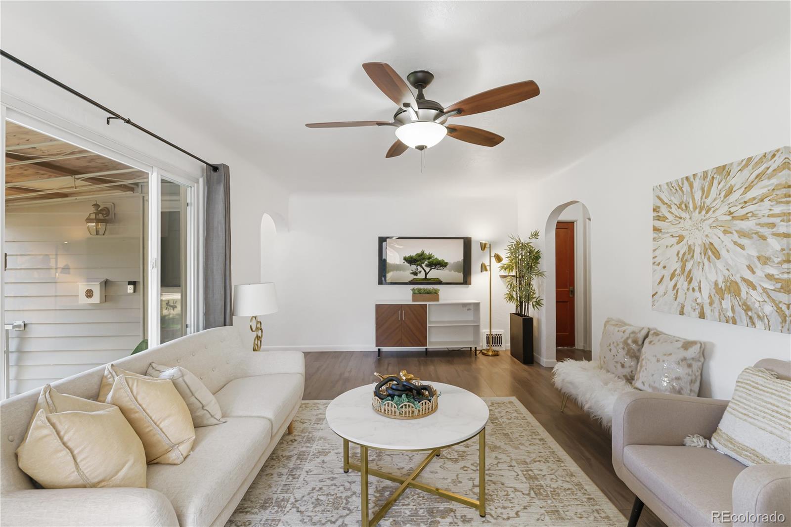 3880 Reed Street Wheat Ridge, CO 80033 - Photo 9 of 40 a living room with furniture and a wooden floor
