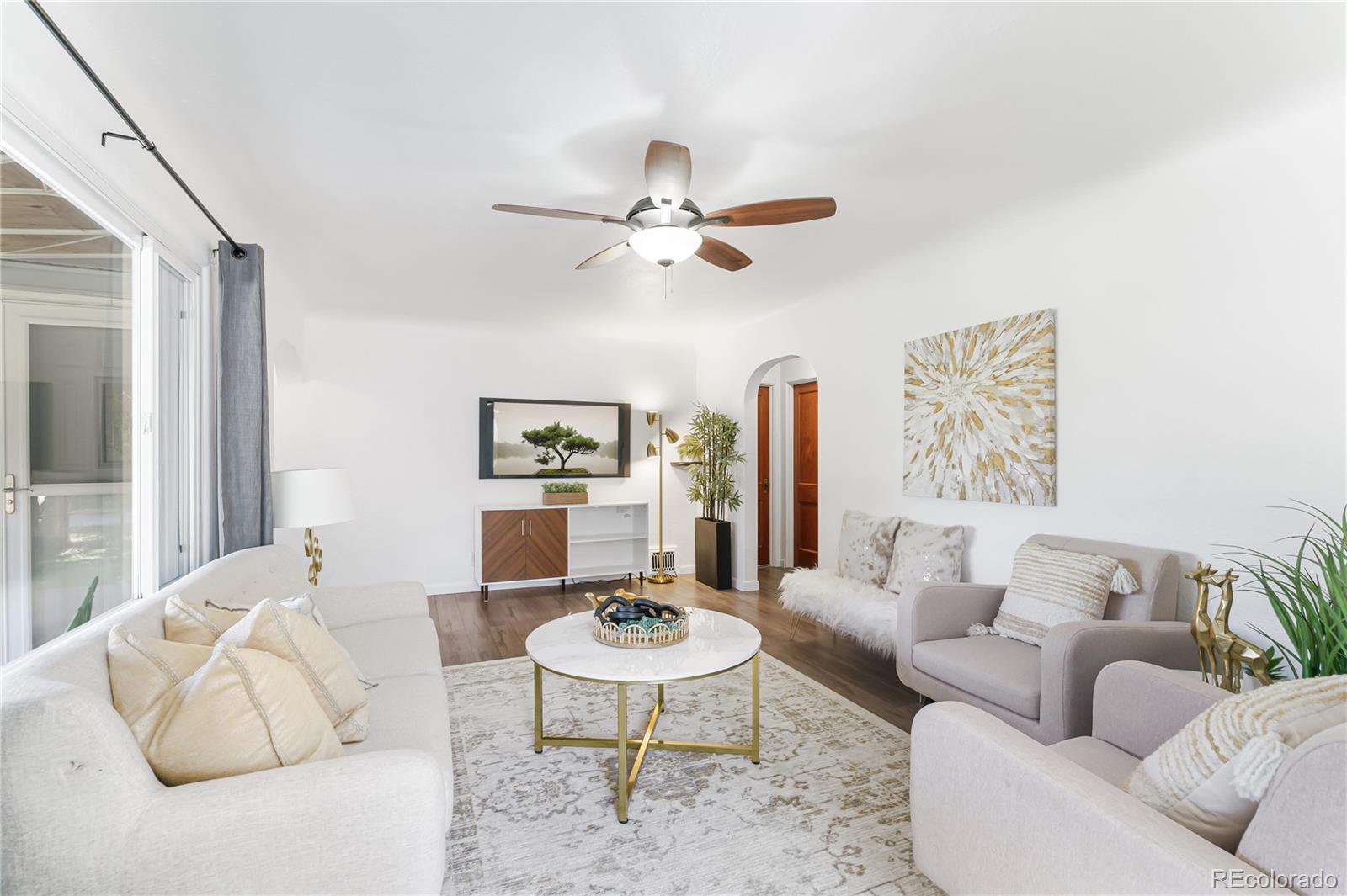 3880 Reed Street Wheat Ridge, CO 80033 - Photo 10 of 40 a living room with furniture a rug and a table