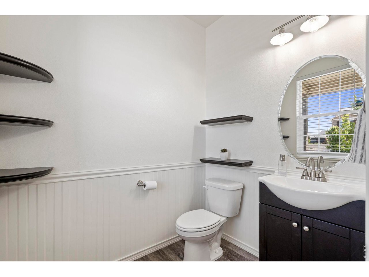 10080 Cedar Street Firestone, CO 80504 - Photo 5 of 38 Half bath is conveniently located at entry with built in shelving included