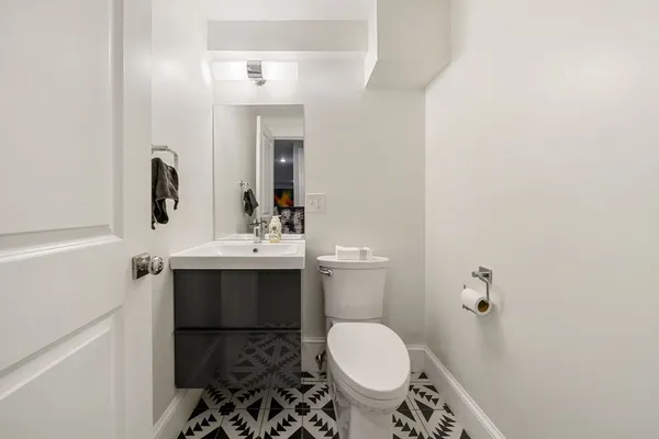 a bathroom with a sink toilet and mirror