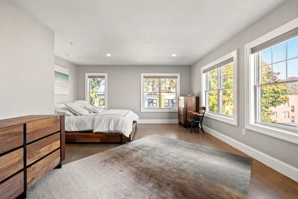 a bedroom with bed and a large window