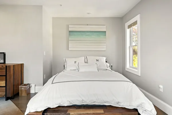 a bedroom with a bed and window