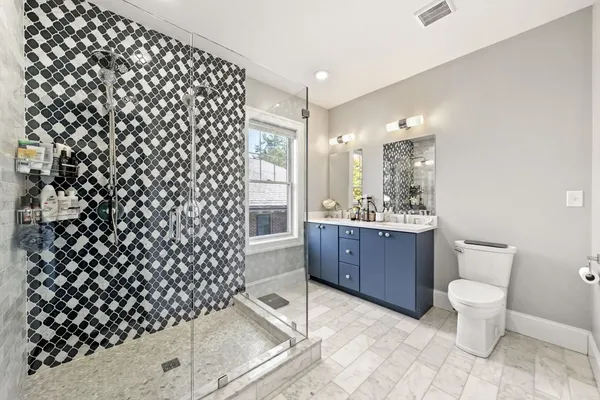 a bathroom with a sink toilet and shower