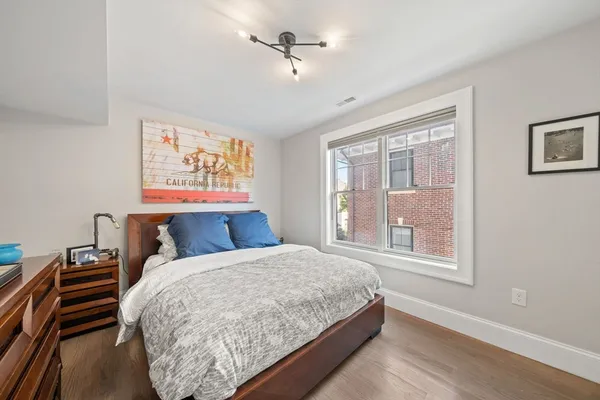 a bed sitting in a bedroom next to a window