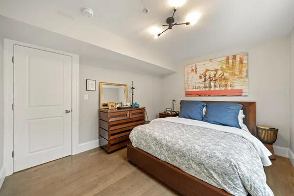 a bedroom with a bed and a chandelier