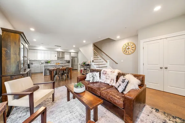 a living room with furniture and kitchen view