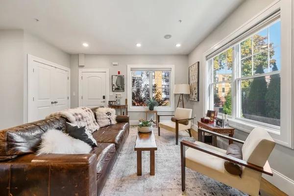 a living room with furniture and large windows