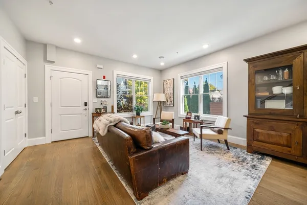 a living room with furniture and large windows