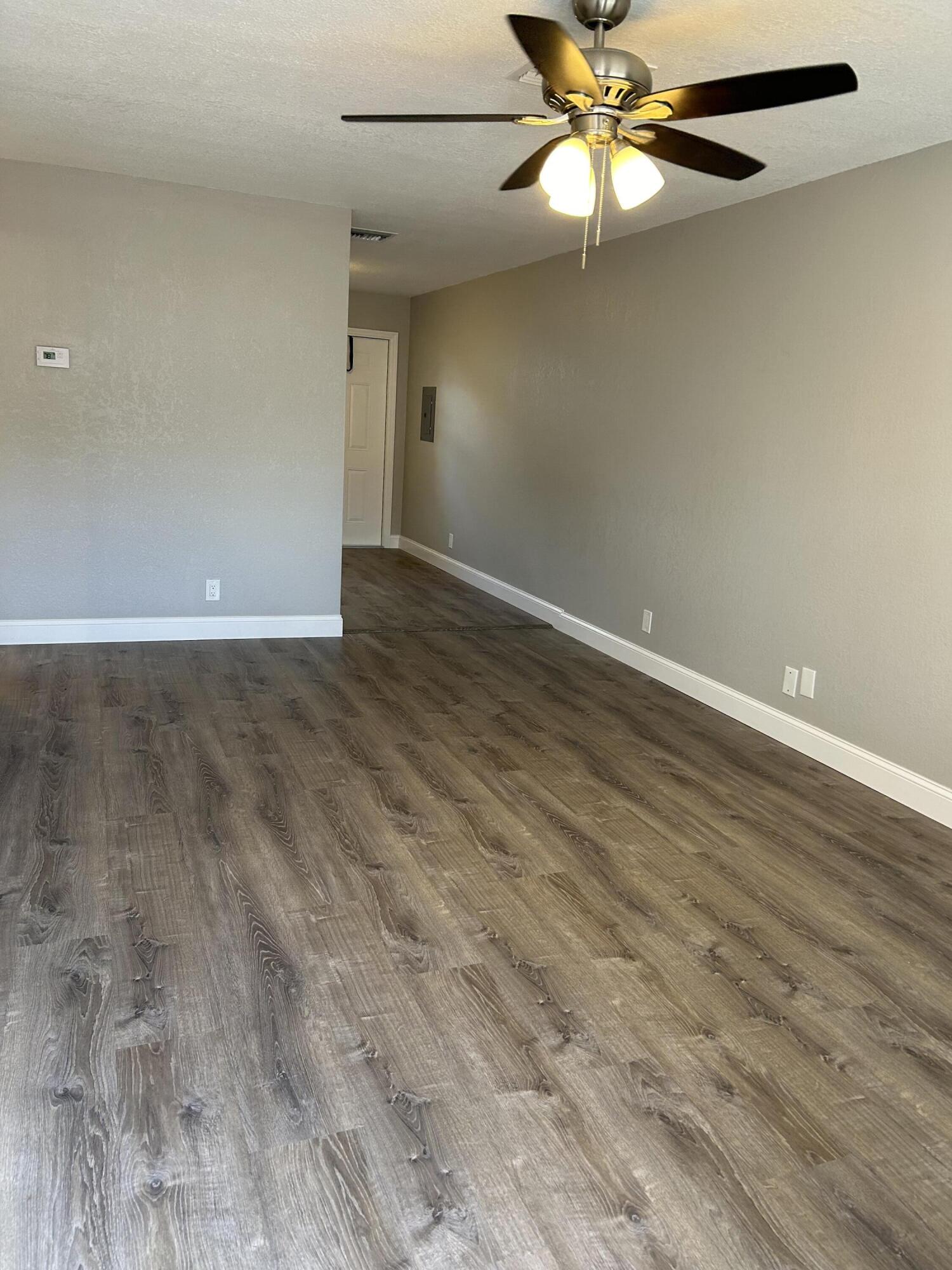 628 North M Street, Unit 1 Lake Worth Beach, FL 33460 - Photo 4 of 11 wooden floor in an empty room with a window