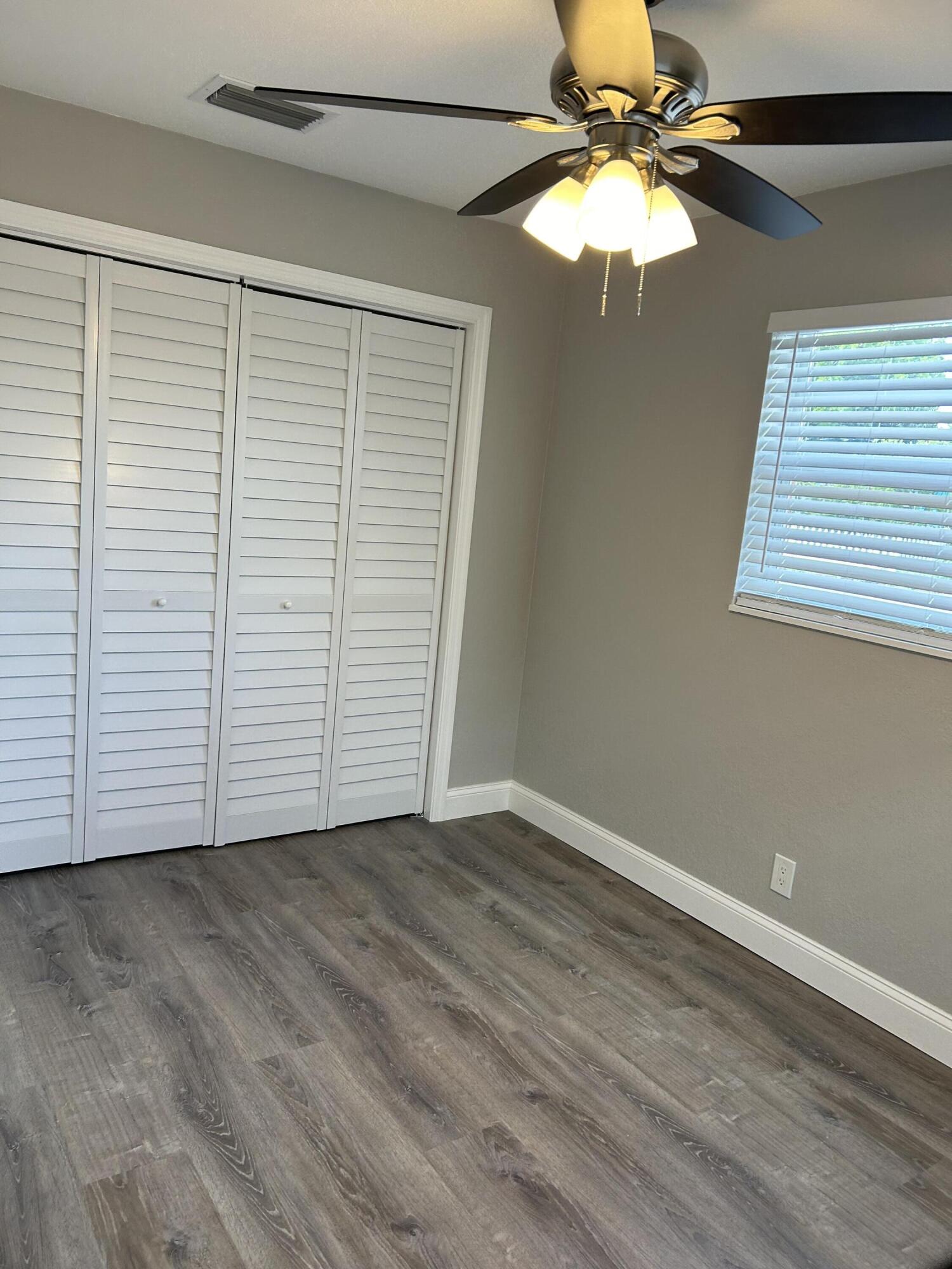 628 North M Street, Unit 1 Lake Worth Beach, FL 33460 - Photo 10 of 11 wooden floor in an empty room