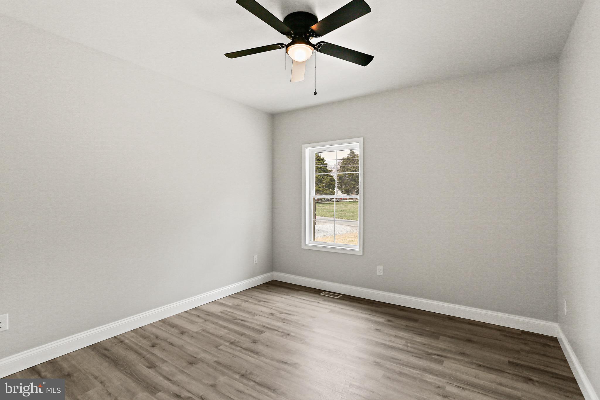 23 Juniper Road Delta, PA 17314 - Photo 13 of 33 an empty room with wooden floor and windows