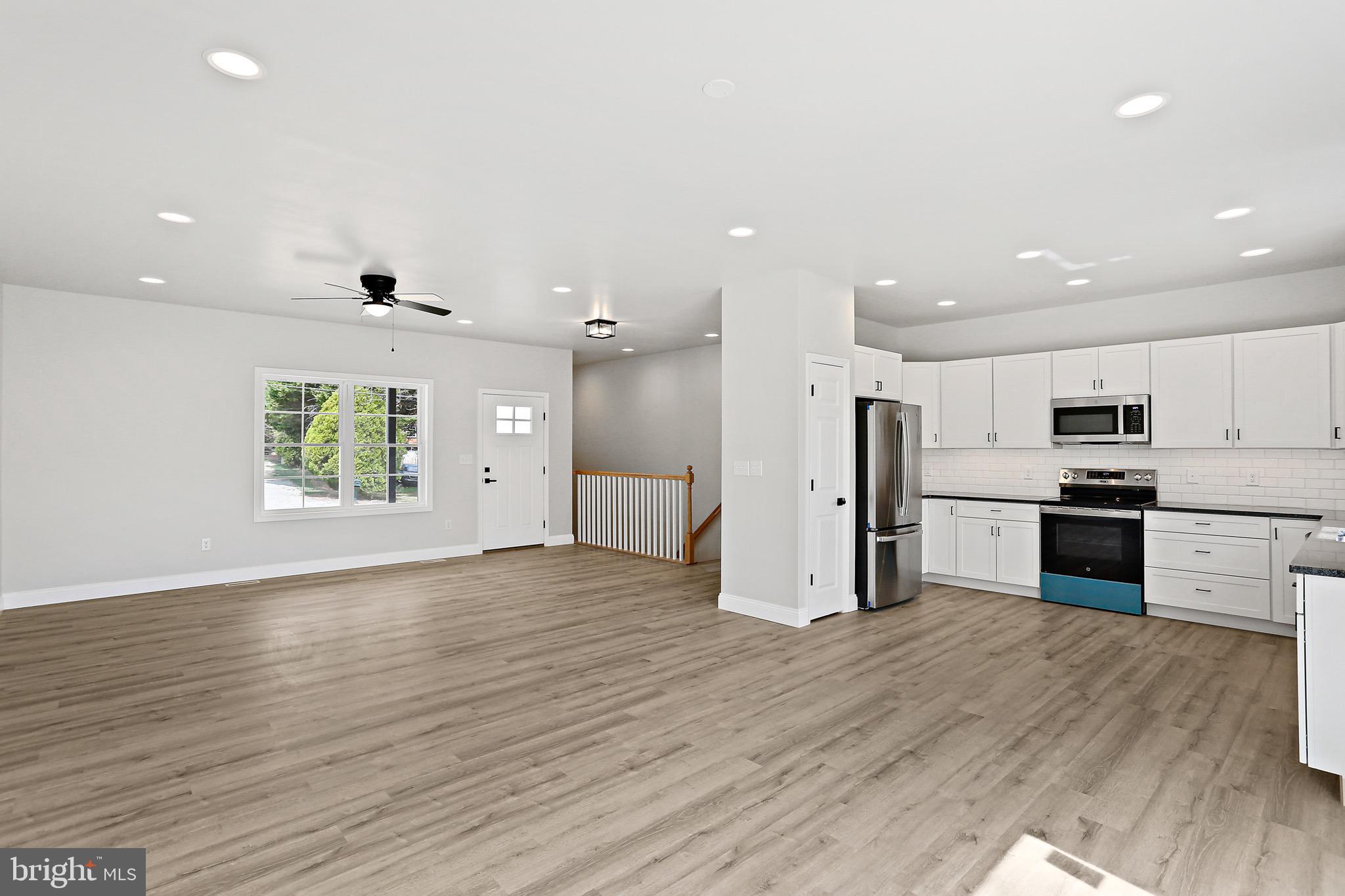 23 Juniper Road Delta, PA 17314 - Photo 23 of 33 a view of kitchen with stainless steel appliances kitchen island wooden floor and window