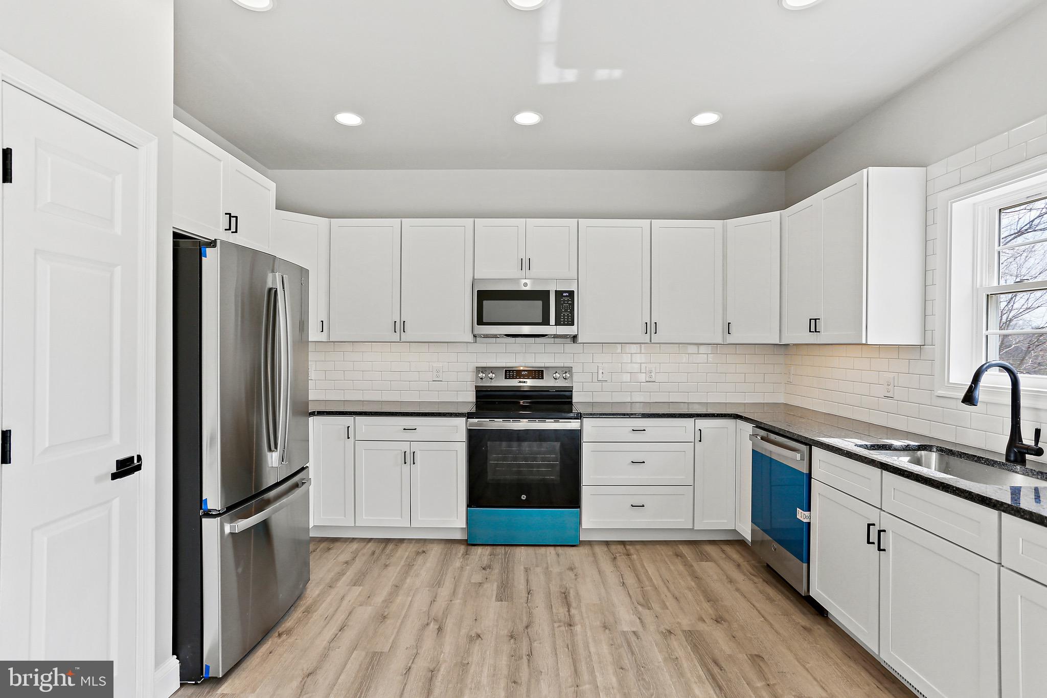 23 Juniper Road Delta, PA 17314 - Photo 24 of 33 a kitchen with a sink a refrigerator a microwave and cabinets