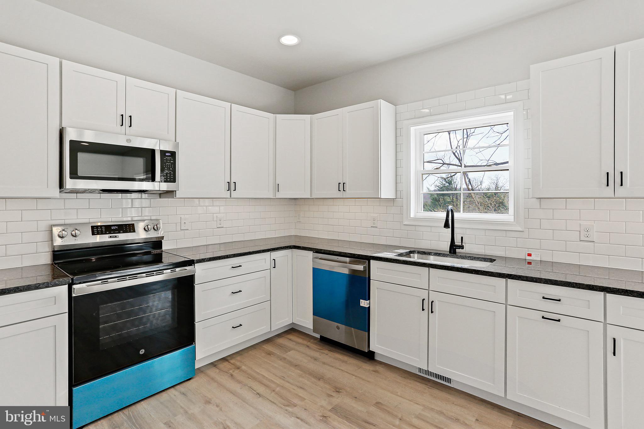 23 Juniper Road Delta, PA 17314 - Photo 25 of 33 a kitchen with cabinets stainless steel appliances a sink and a window