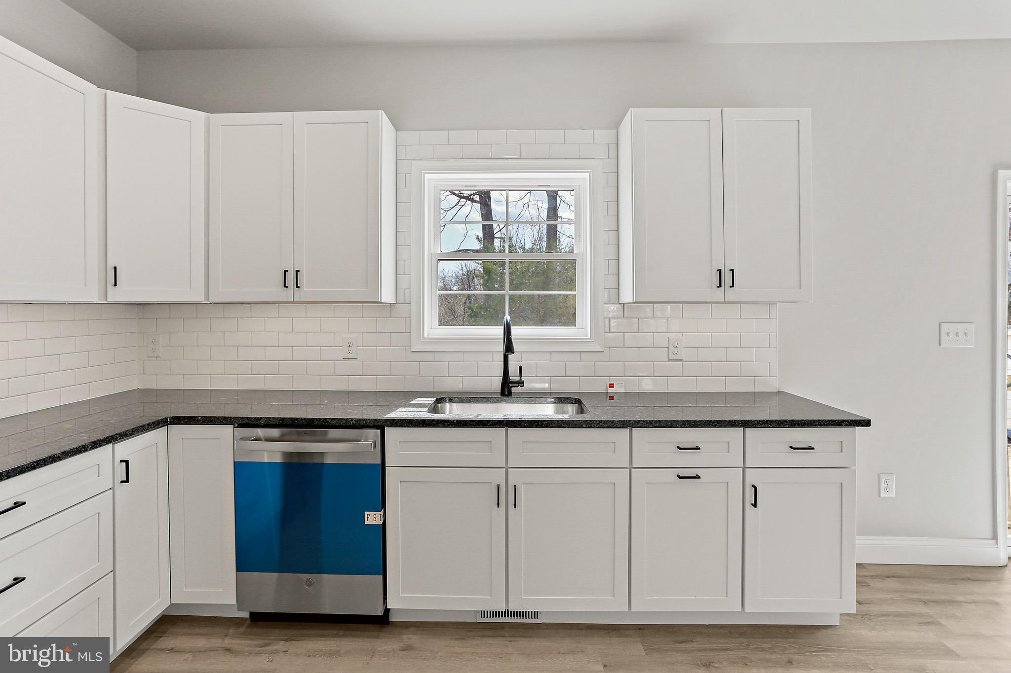 23 Juniper Road Delta, PA 17314 - Photo 26 of 33 a kitchen with granite countertop white cabinets and sink