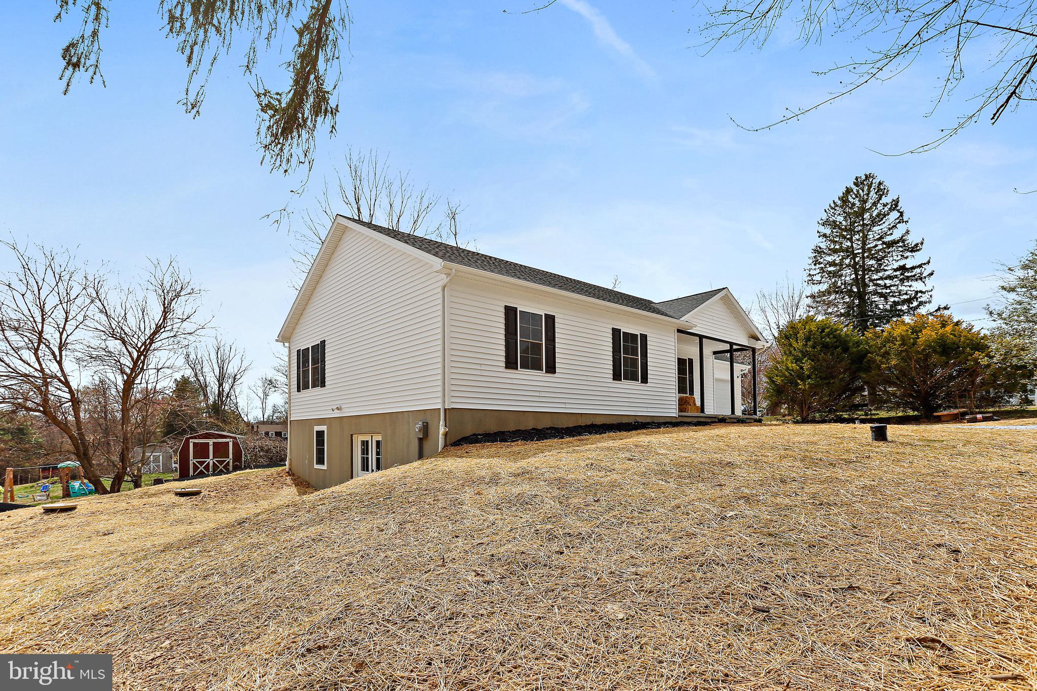 23 Juniper Road Delta, PA 17314 - Photo 3 of 33 a front view of house with yard and trees in the background