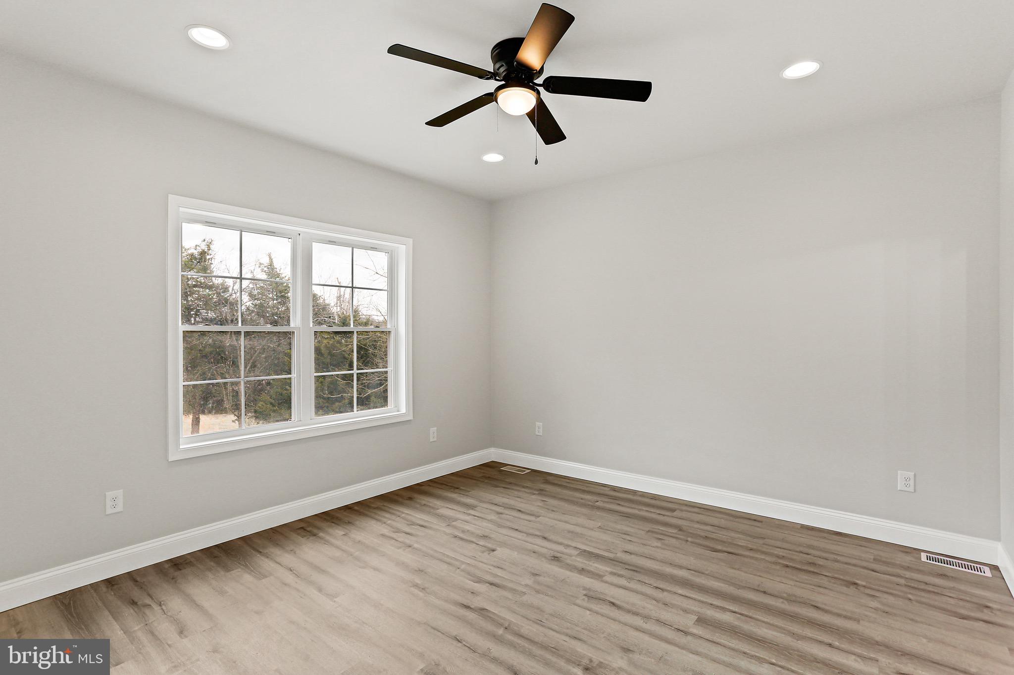 23 Juniper Road Delta, PA 17314 - Photo 6 of 33 an empty room with wooden floor and windows