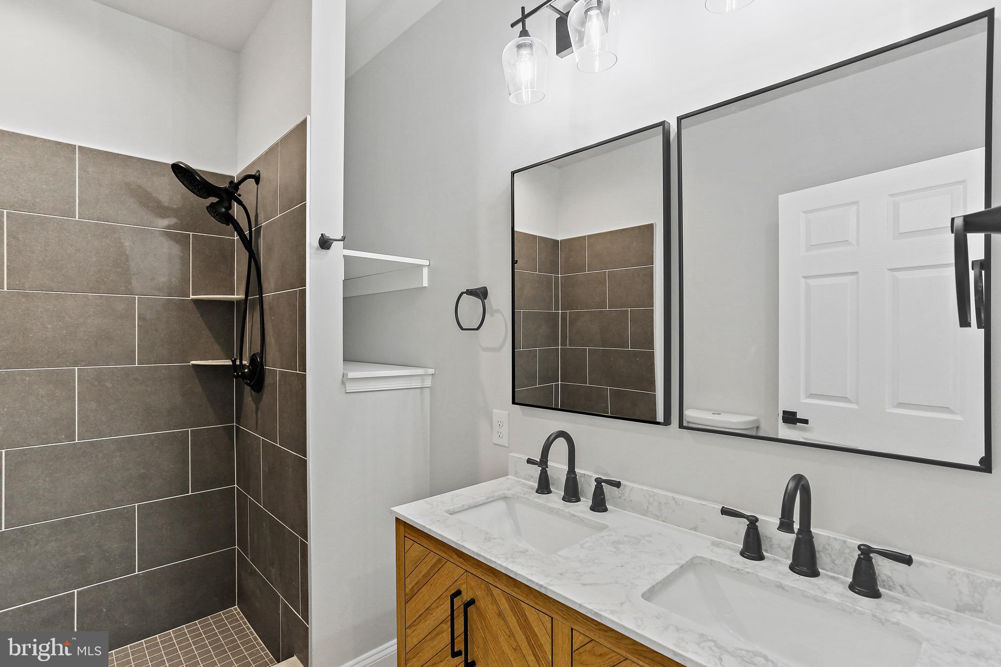 23 Juniper Road Delta, PA 17314 - Photo 9 of 33 a bathroom with a granite countertop sink a mirror and shower