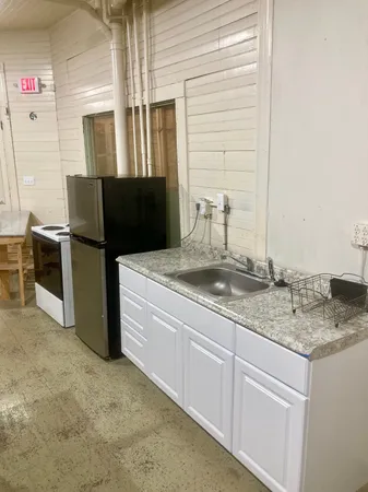 a kitchen with stainless steel appliances granite countertop a sink and a refrigerator