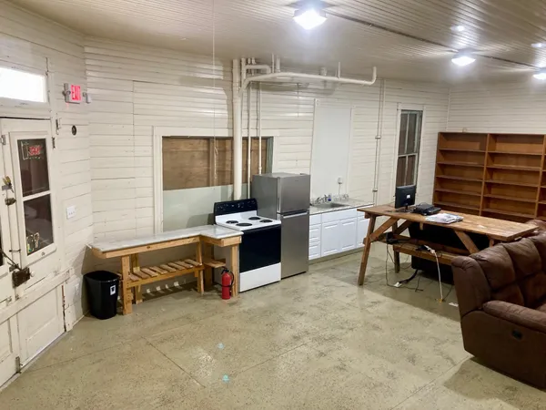 a room with furniture a flat screen tv and gym equipment