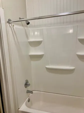 a bathroom with a shower and a sink