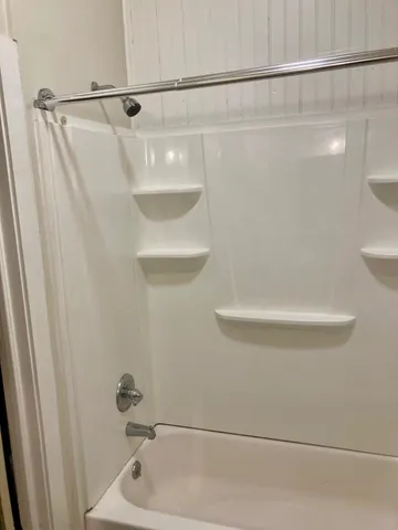 a bathroom with a shower and a sink