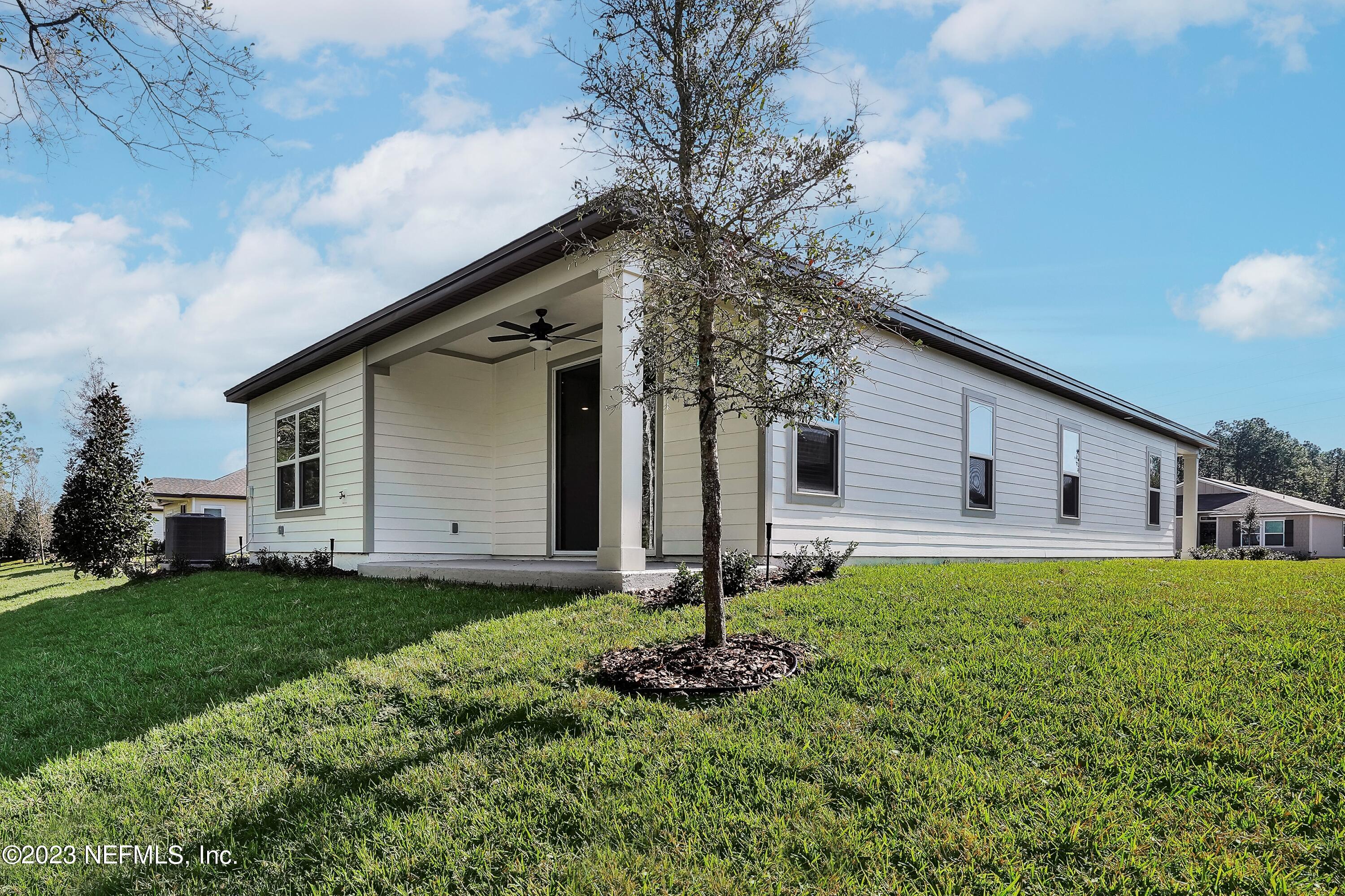 654 Morgans Treasure Road St. Augustine, FL 32084 - Photo 1 of 8 a front view of house with yard and green space