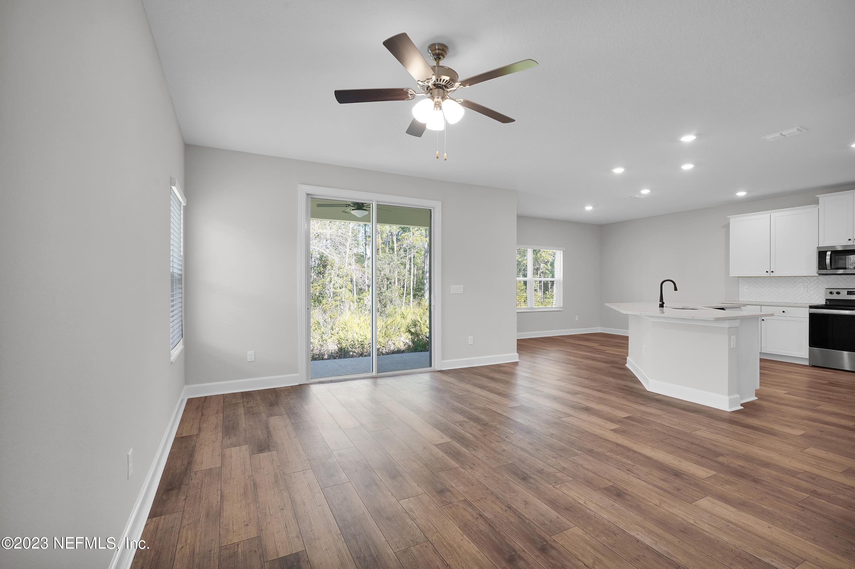 654 Morgans Treasure Road St. Augustine, FL 32084 - Photo 5 of 8 a view of an empty room with window and wooden floor