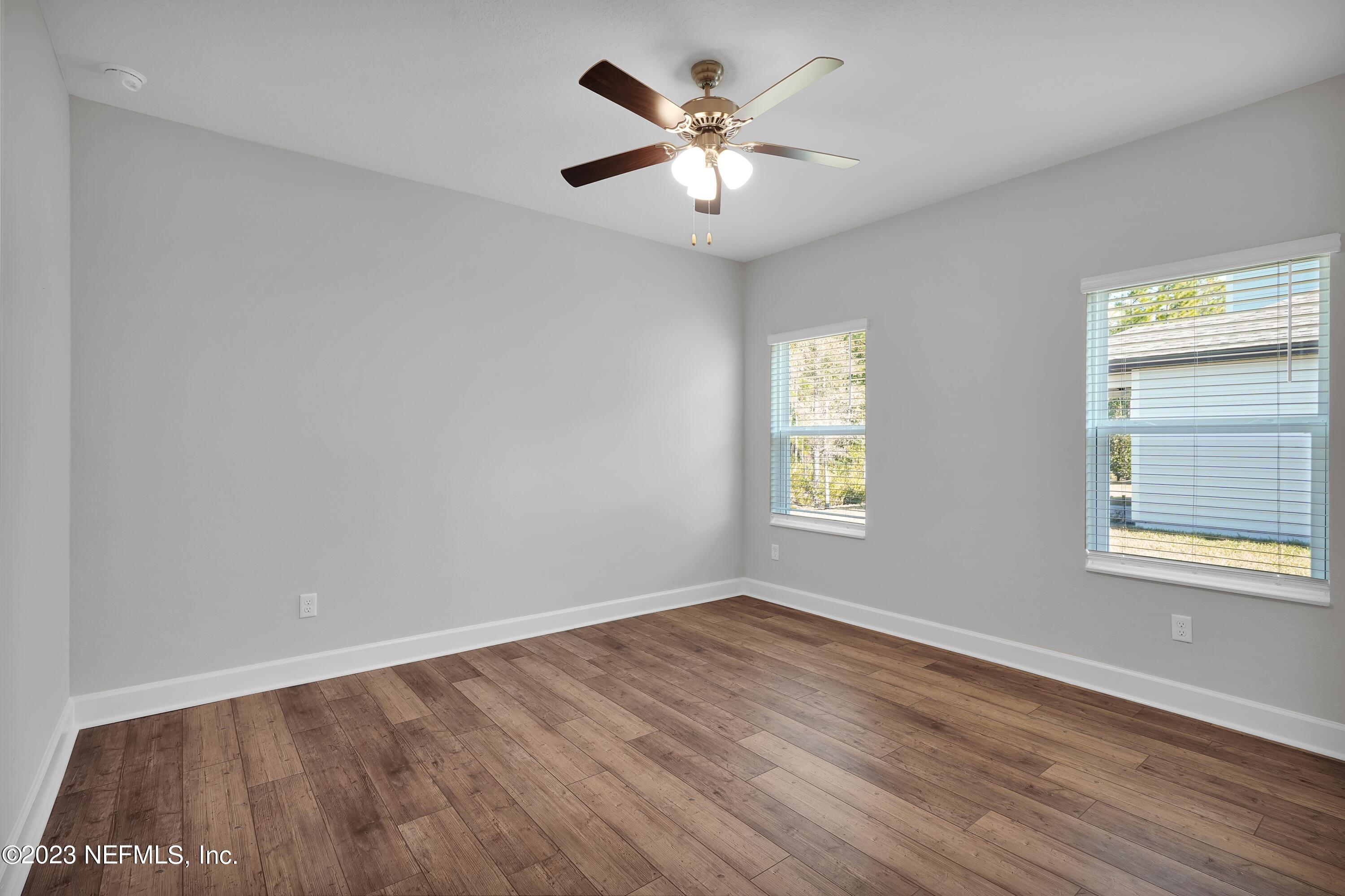 654 Morgans Treasure Road St. Augustine, FL 32084 - Photo 6 of 8 a view of an empty room with wooden floor and a window
