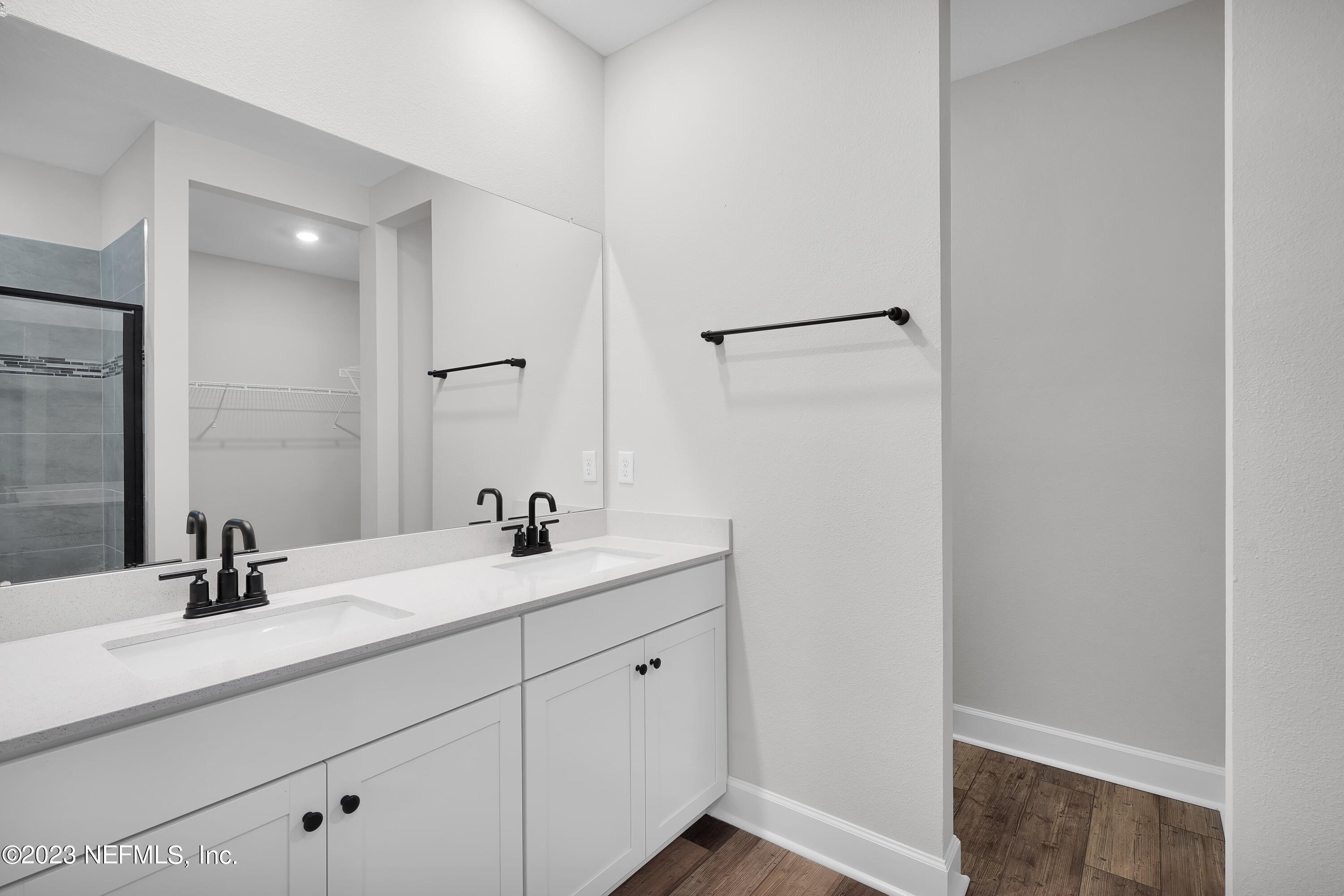 654 Morgans Treasure Road St. Augustine, FL 32084 - Photo 7 of 8 a bathroom with a sink and a mirror