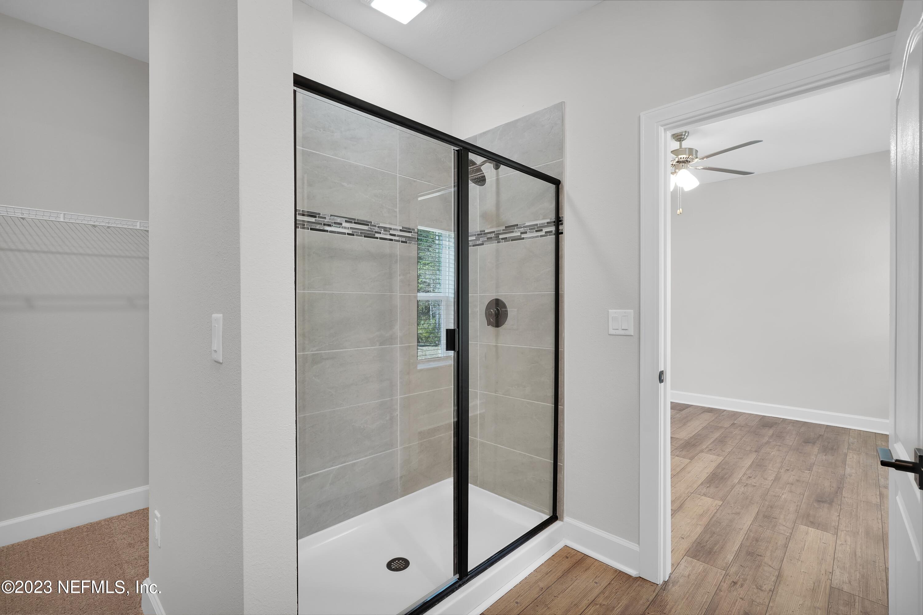 654 Morgans Treasure Road St. Augustine, FL 32084 - Photo 8 of 8 a bathroom with a glass shower door