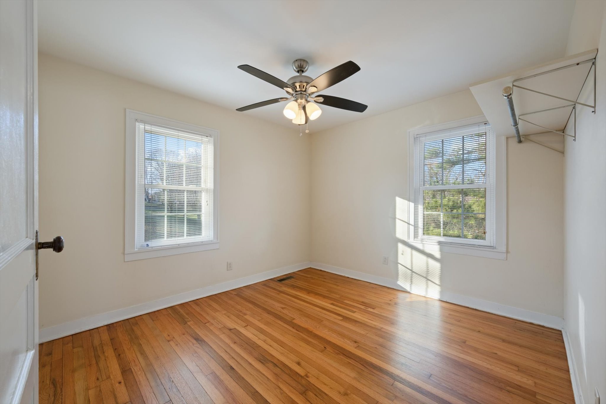 105 Arnold Street Centerville, TN 37033 - Photo 13 of 15 a view of an empty room with a window and wooden floor