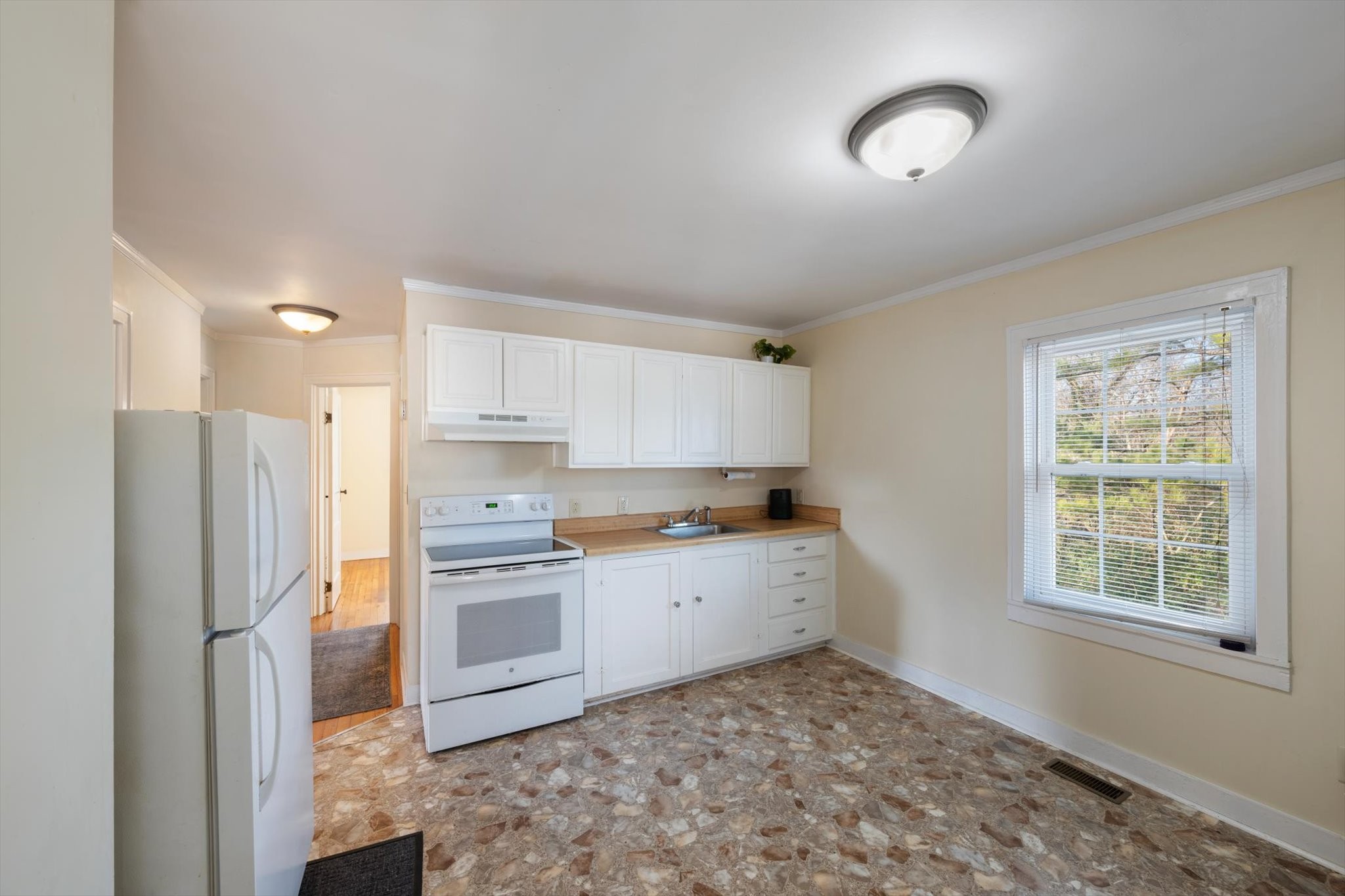 105 Arnold Street Centerville, TN 37033 - Photo 9 of 15 a kitchen with stainless steel appliances granite countertop a refrigerator sink and stove