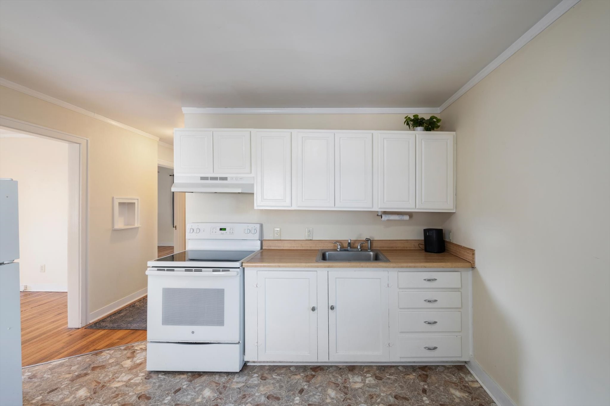 105 Arnold Street Centerville, TN 37033 - Photo 10 of 15 a kitchen with granite countertop white cabinets and white appliances