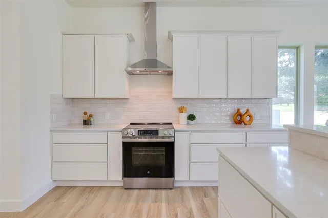 a kitchen with stainless steel appliances granite countertop a sink and a stove