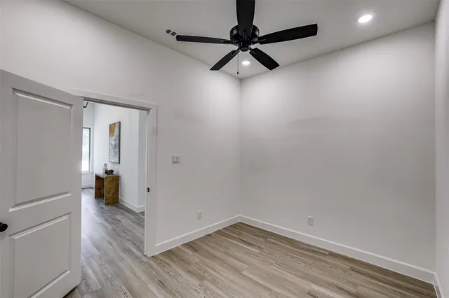 a view of a storage and utility room with wooden floor