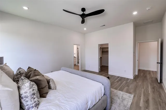 a bedroom with a bed and a ceiling fan