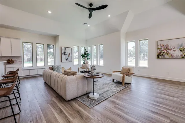 a living room with furniture and a wooden floor