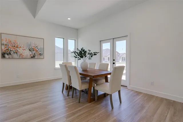 a dining room with furniture and wooden floor