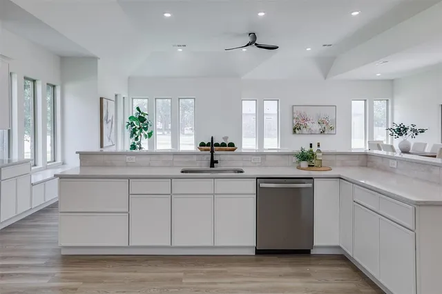 a kitchen with a sink cabinets and window