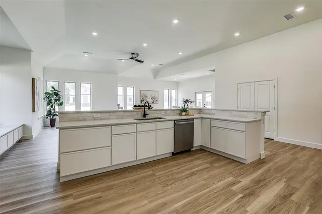 a kitchen with white cabinets and white appliances