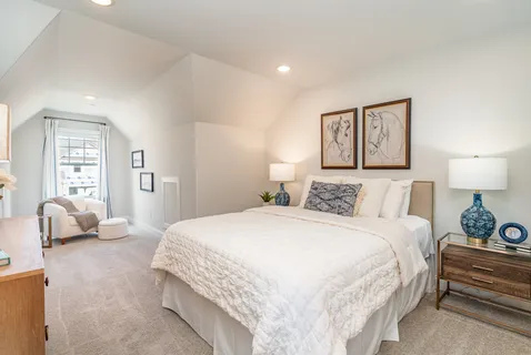 a bedroom with a bed and lamp