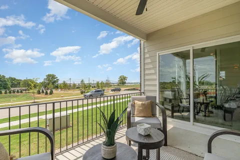 a view of a balcony with furniture