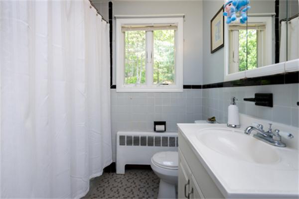 930 Central Avenue Needham, MA 02492 - Photo 16 of 21 a bathroom with a sink a toilet and a window