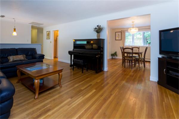 930 Central Avenue Needham, MA 02492 - Photo 4 of 21 a living room with furniture and a flat screen tv with kitchen view