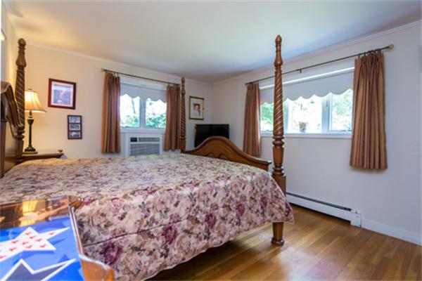 930 Central Avenue Needham, MA 02492 - Photo 10 of 21 a bed sitting in a spacious bedroom next to a window