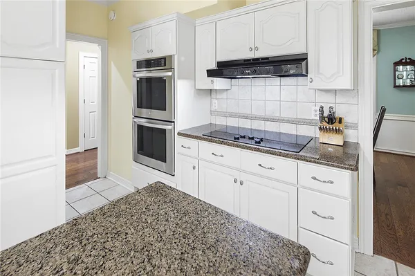 a kitchen with cabinets and chandelier