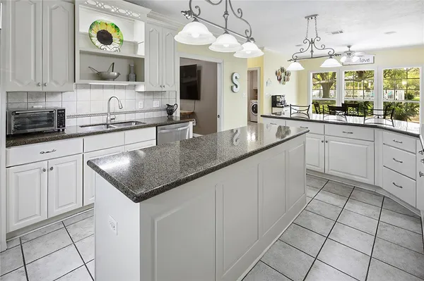 a view of a dining room with furniture wooden floor and chandelier