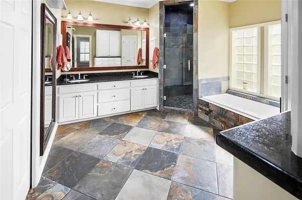 a living room with furniture a ceiling fan and a window