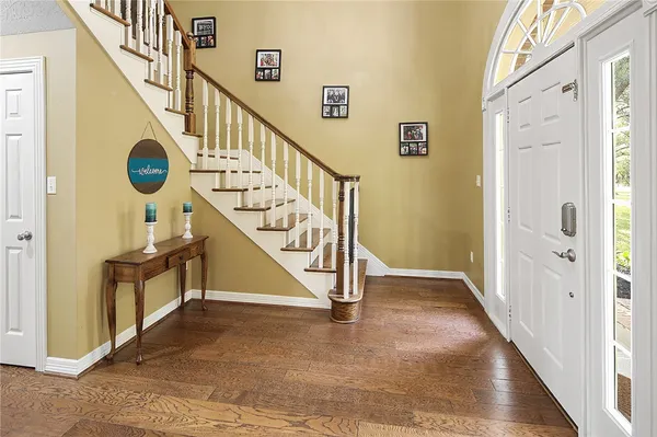 a view of a dining room with furniture and wooden floor